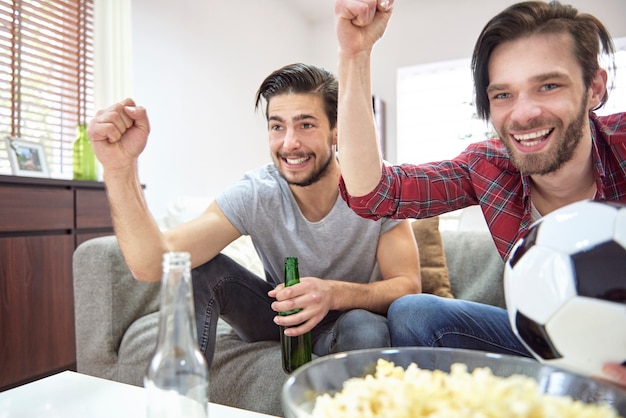 Free photo cheerful men are proud of their soccer team