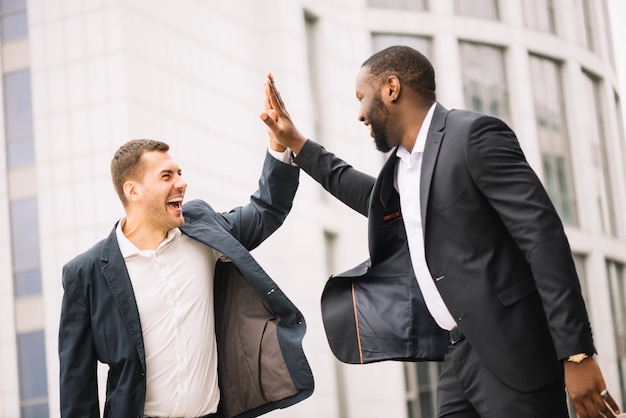 Cheerful men high-fiving