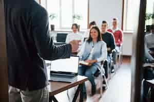 Free photo cheerful mood. group of people at business conference in modern classroom at daytime