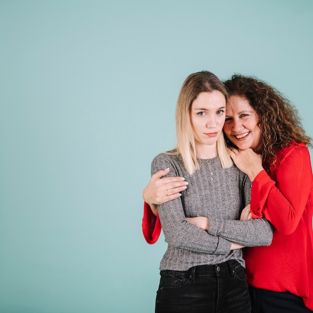 Cheerful mother embracing daughter