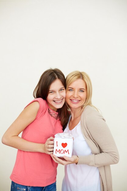 Cheerful mother with a gift from her daughter