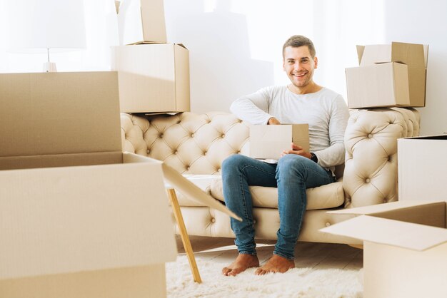 Cheerful moved in man with box