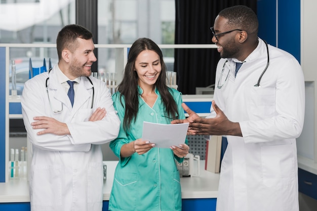 Cheerful multiethnic medics with papers