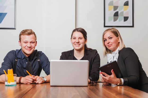 Cheerful office team looking at camera