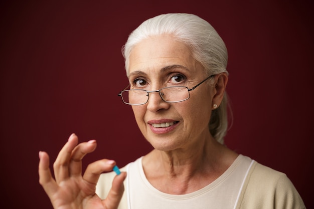 Cheerful old woman showing okay gesture.