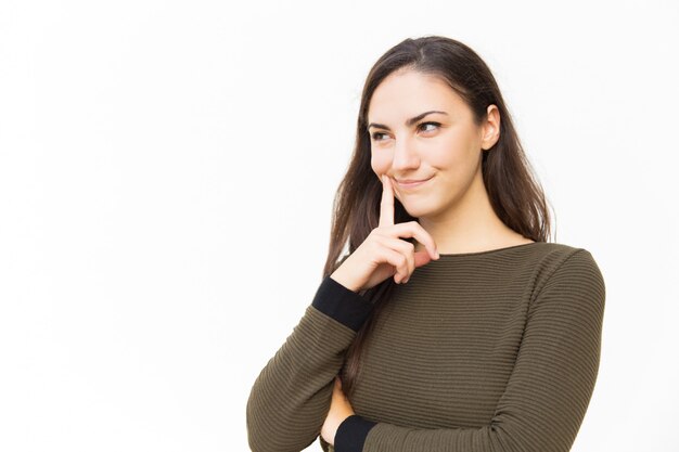 Cheerful pensive female woman touching cheek