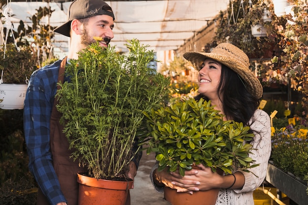 Cheerful people carrying pots