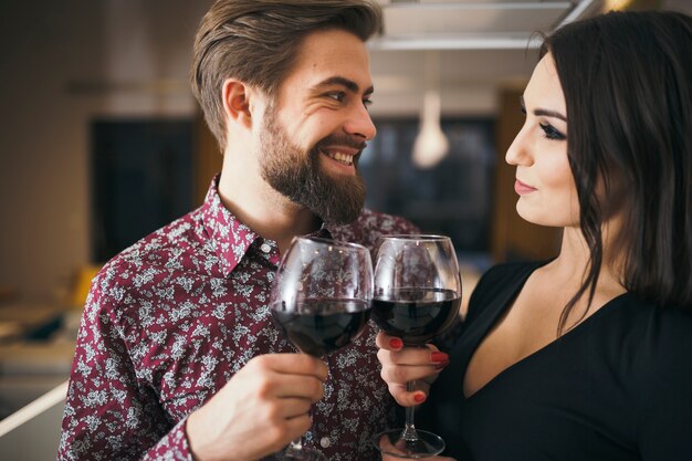 Cheerful people enjoying romantic evening with wine