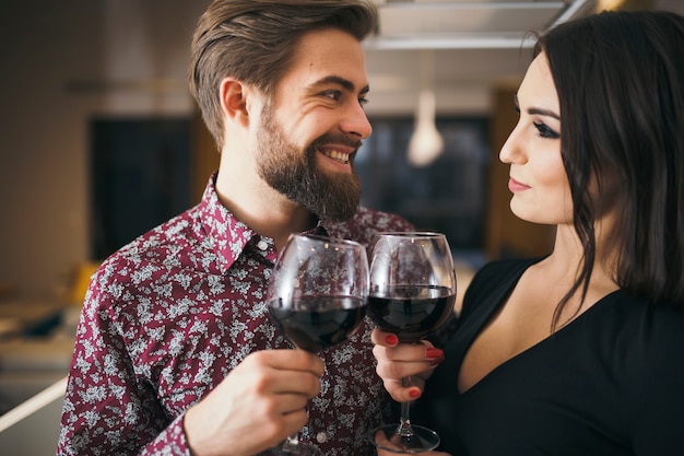 Cheerful people enjoying romantic evening with wine