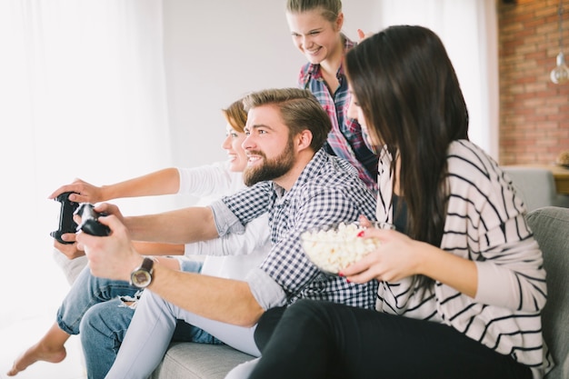 Free photo cheerful people playing game on party