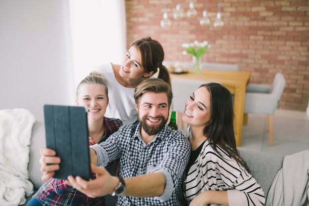 Cheerful people posing for selfie at home