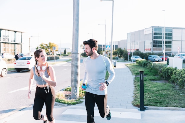 Cheerful people running on crosswalk