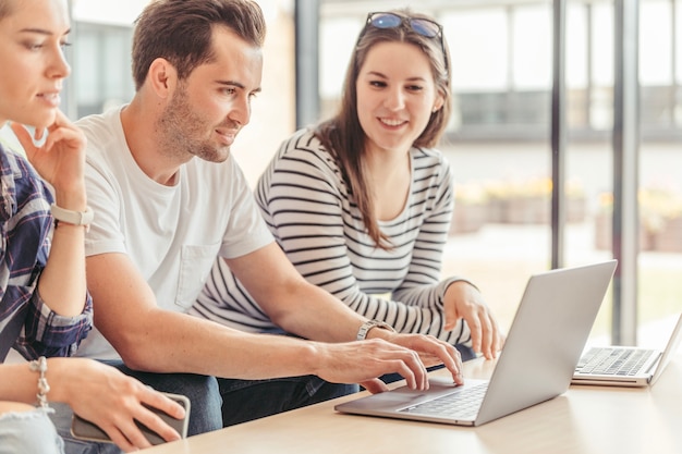 Cheerful people watching laptop