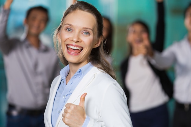 Cheerful Pretty Business Woman Showing Thumb Up