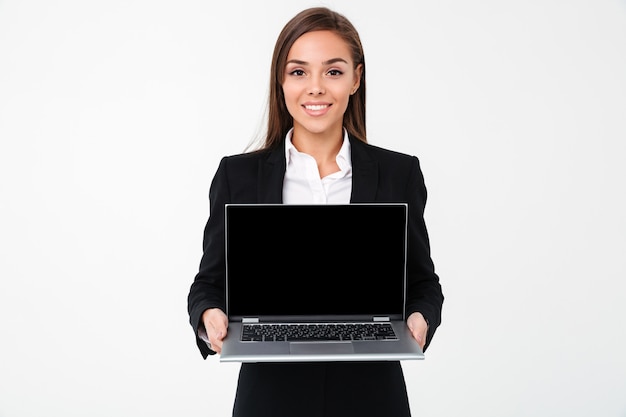 Cheerful pretty businesswoman showing display of laptop computer