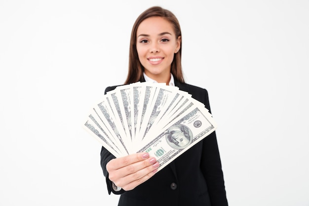 Cheerful pretty businesswoman showing money