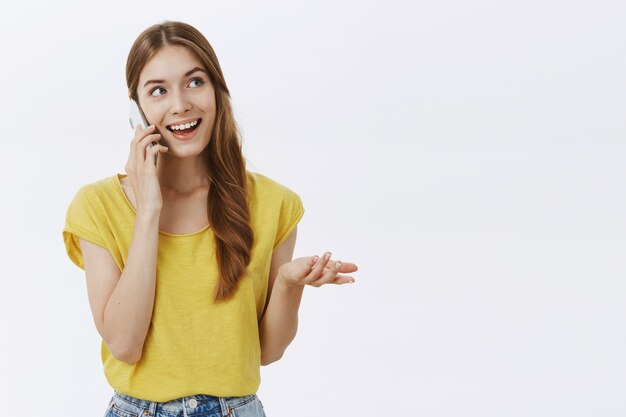 Cheerful pretty girl smiling, talking on mobile phone happy