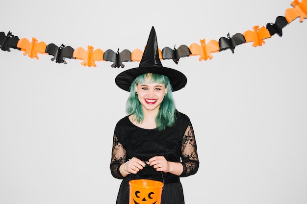 Cheerful pretty girl with pumpkin bag