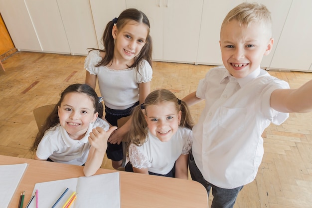 Cheerful pupils taking selfie