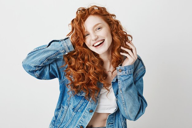 Cheerful redhead girl smiling laughing . Copy space.