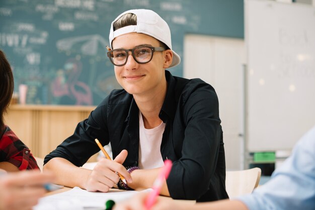 Cheerful schoolboy in classroom