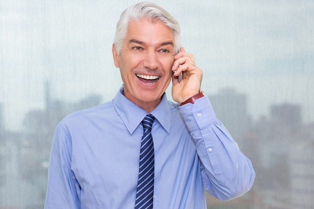 Cheerful senior businessman talking on cellphone