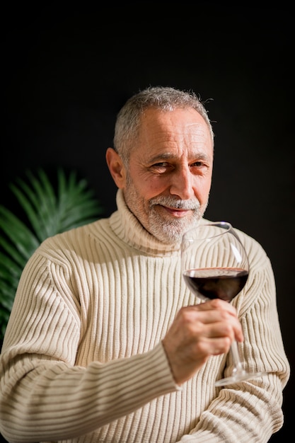 ワインのグラスと陽気な年配の男性