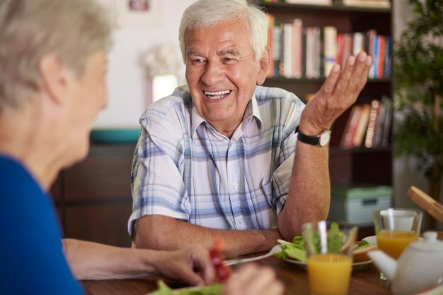 Cheerful senior marriage eating breakfast together
