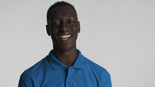 Cheerful smiling African American guy looking happy on camera over white background Positive expression