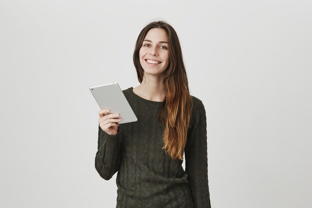 Cheerful smiling pretty woman with digital tablet