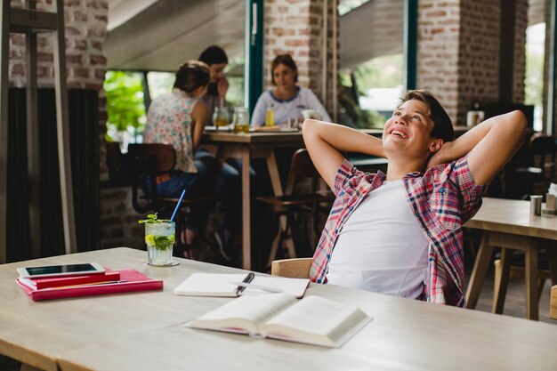 Cheerful student relaxing at table