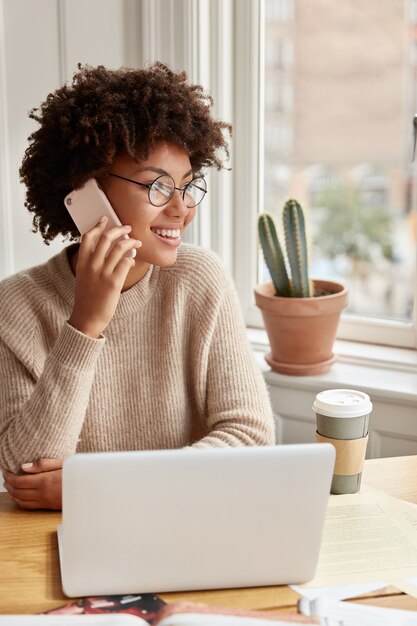 Cheerful student working at home