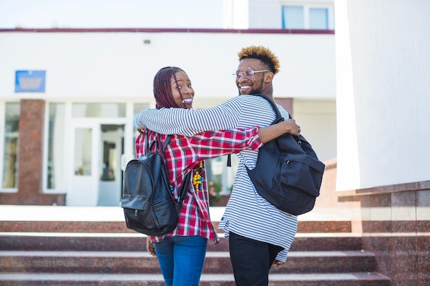 Free photo cheerful students posing on stairway