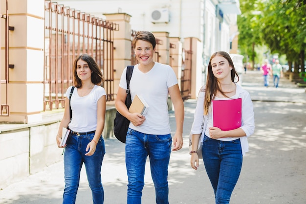 Cheerful students posing at street