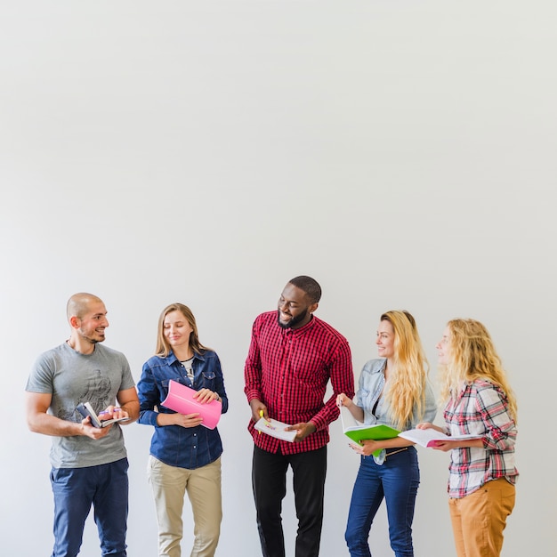 Cheerful students with notepads