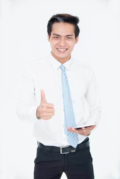 Cheerful successful Asian manager showing thumb-up