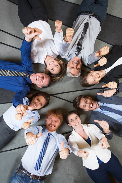 Cheerful Successful Business Team with Thumbs Up