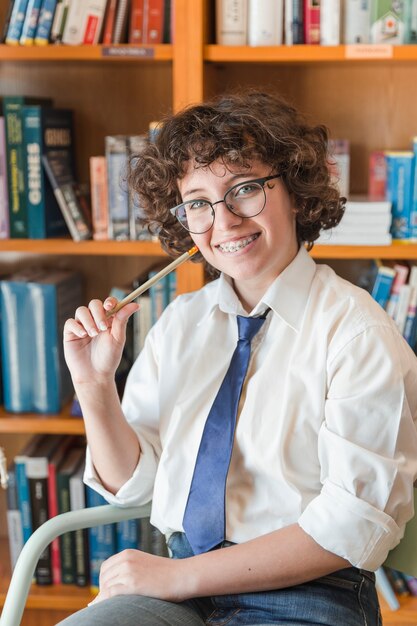 Cheerful teen girl with pencil