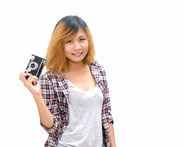 Cheerful teenager holding a vintage camera