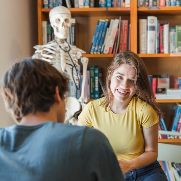 Cheerful teenager studying with boyfriend