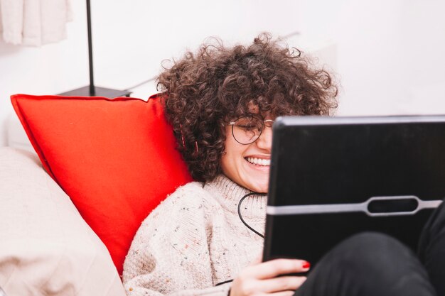 Cheerful teenager using laptop