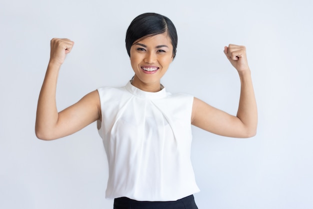 Cheerful Thai girl showing strength