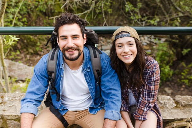 Cheerful travellers looking at camera