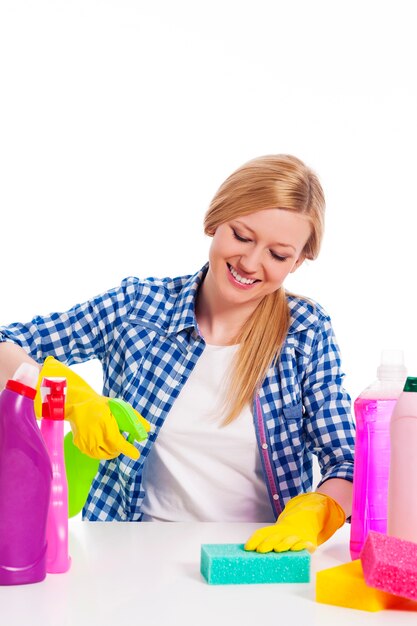 Cheerful woman cleaning the table