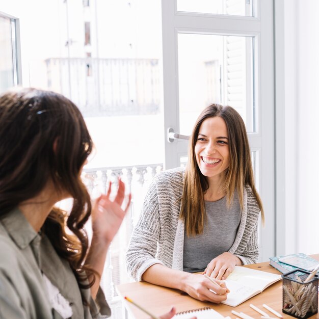 Cheerful woman drawing and talking