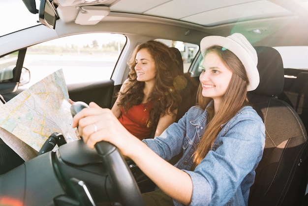 Cheerful woman driving car