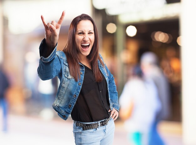 Cheerful woman giving the devil horns gesture