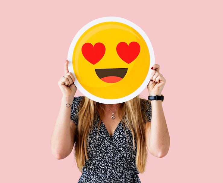 Free Photo cheerful woman holding emoticon icon