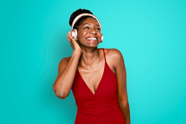 Cheerful woman listening to music through headphones digital device