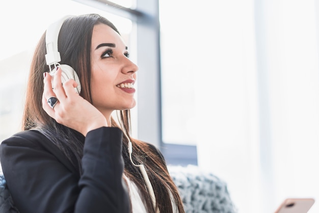 Cheerful woman listening to music